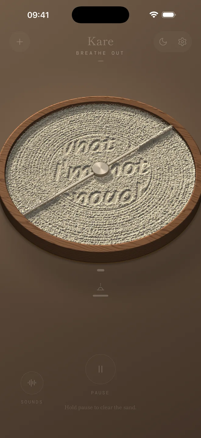 A rod turning slowly through the sand, smoothing the words away